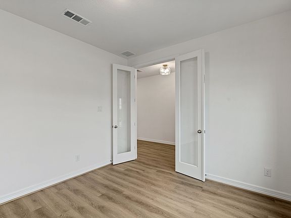 An additional view of the office with modern French doors.