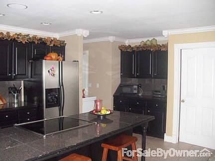 Kitchen : Black granite countertops and Whirlpool Stainless appliances..nice Island bar.