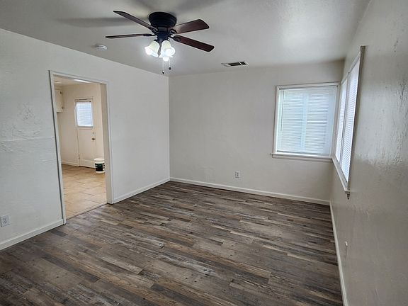 Living room with view to kitchen.