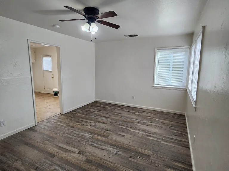 Living room with view to kitchen.