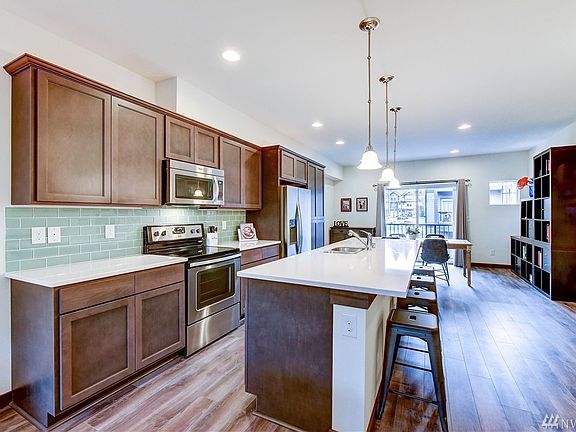 Kitchen facing the dining space and balcony