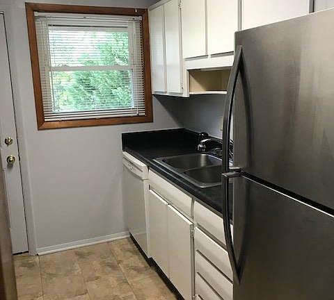 Bright kitchen with over sized sink and plenty of cabinets.