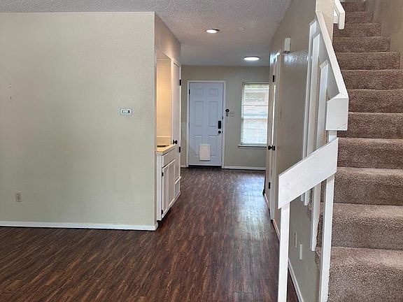 From Front Door Looking towards Hallway, Wet Bar, Kitchen and Dining Area