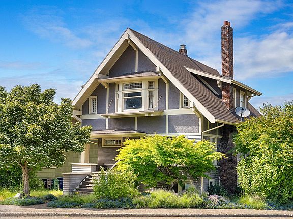 Stately craftsman home with mature landscaping, in convenient Queen Anne hilltop location.