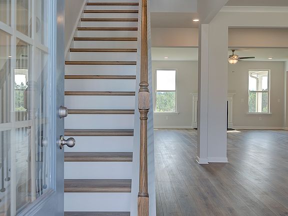 McKinley II front door with glass panels opening to foyer with LVP flooring at Brighton in Locust Gr