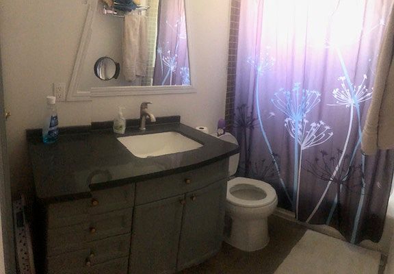 remodeled full size bathroom with tub and shower.