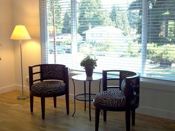Living room is bright with a large window and flows into open concept kitchen and family room.