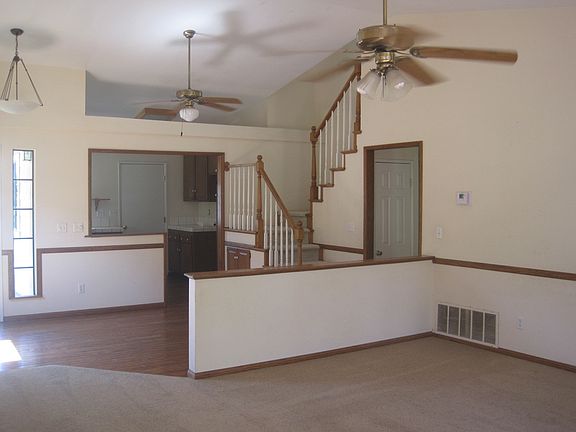 Dining area to kitchen, vaulted ceilings and ceiling fan