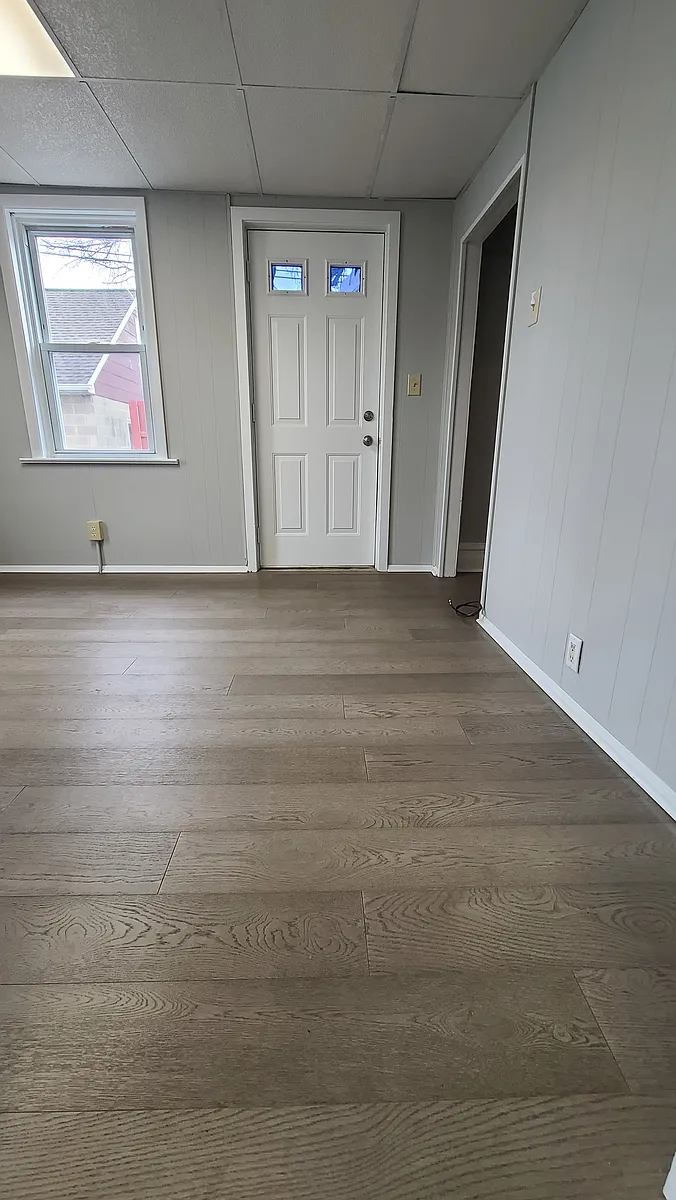Living area 1st floor - new hardwood flooring throughout - 326 E 8th St #1