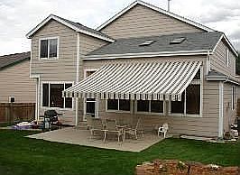 Remote controlled retractable awning over patio.