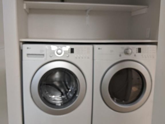 In unit washer and dryer with pedestals and storage shelves