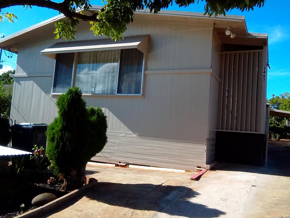 Front view of house with chain link gates.
