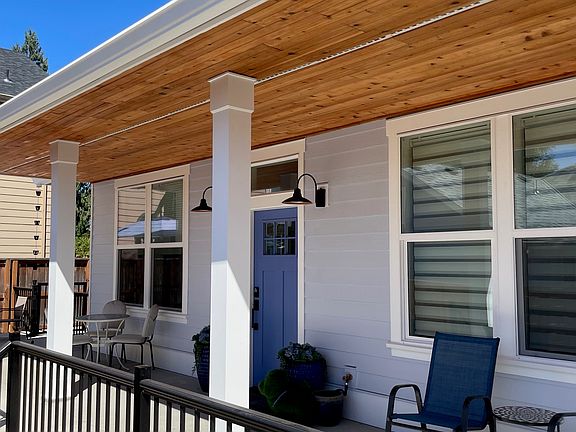 Porch and front door, more yard past fence - room for pets