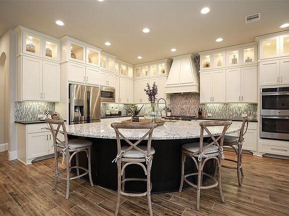 WOW! A chef's dream! Lots of cabinets, drawers and an oversized island for those times you are entertaining. Double ovens and even a built in garbage can next to the sink with 2 garbage cans!