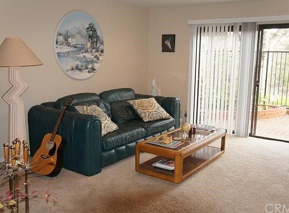 Living Room with Cozy Fireplace & Access to Backyard Patio