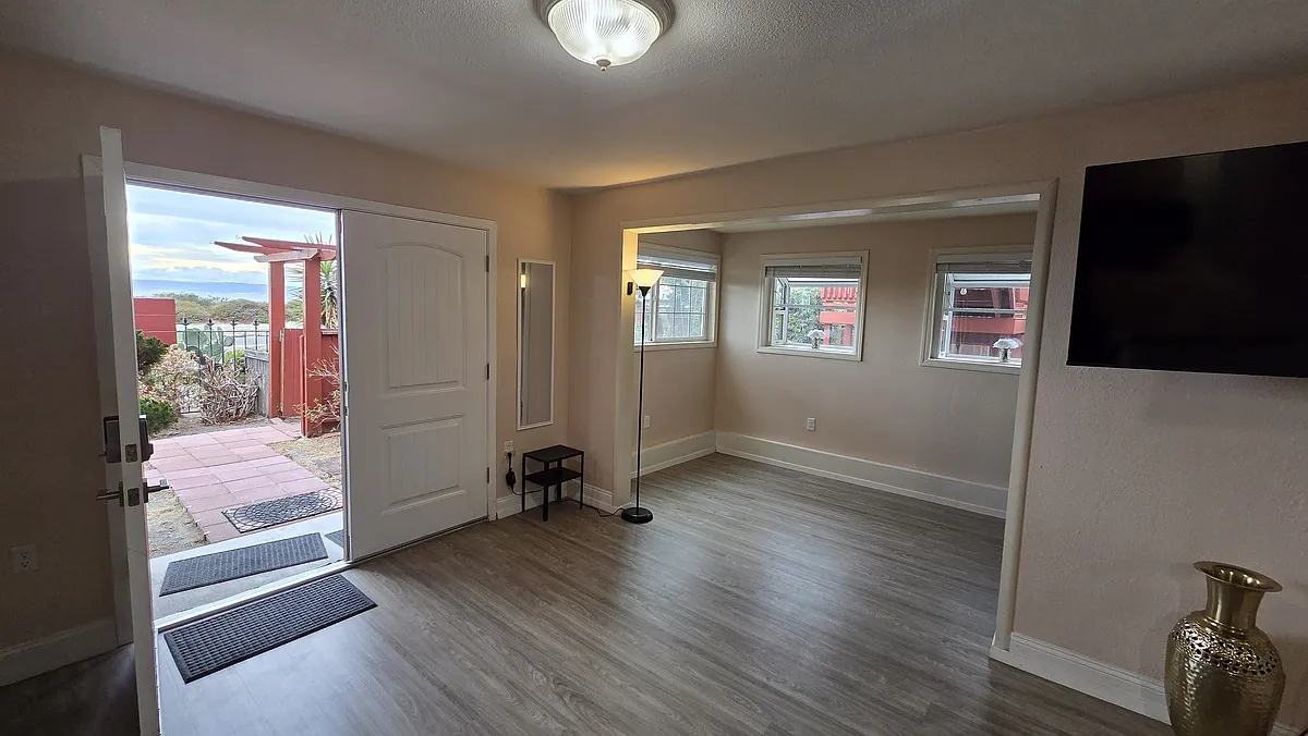 Living room - also showing the view out the main door and the bonus nook - 301 Coral Reef Rd