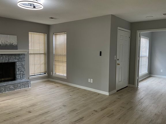 Hardwood flooring throughout living room, both bedrooms, and closets