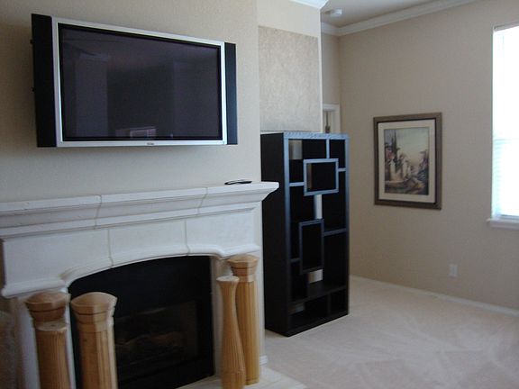 Living room wired for tv above the fireplace