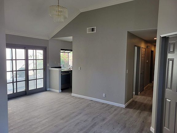 Dining Room w/ High Ceiling and Chandelier