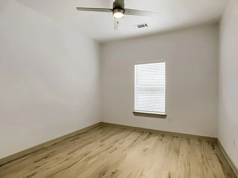bedroom with window and ceiling fan