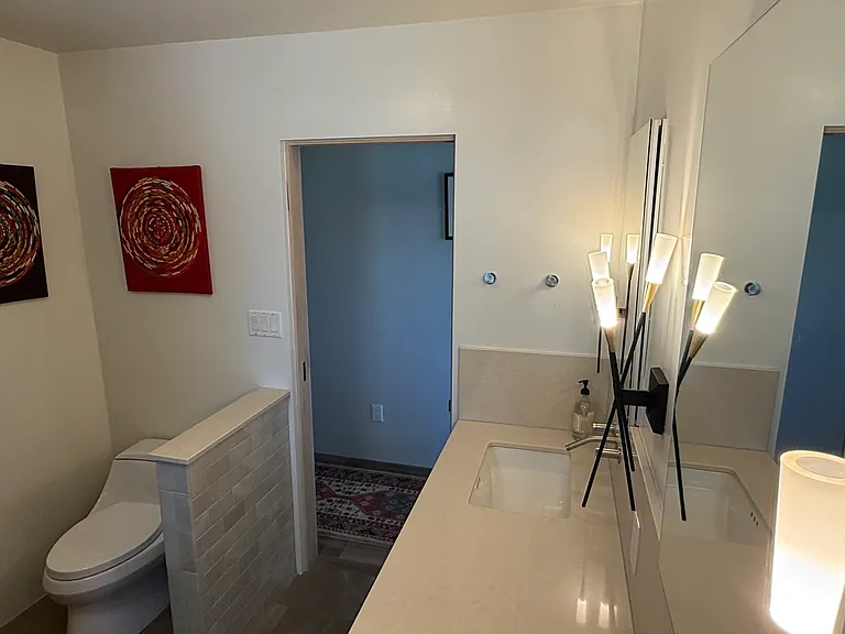 Master bath with two sinks, and more local art