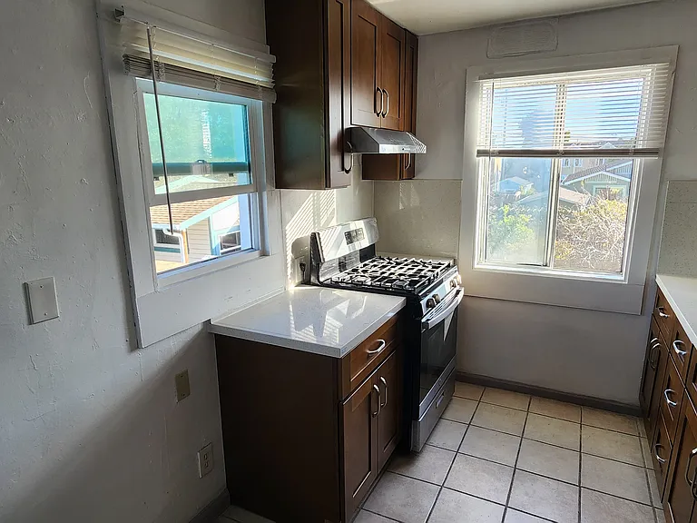 big kitchen with plenty of natural light . lots of cabinets for all your cooking essentials