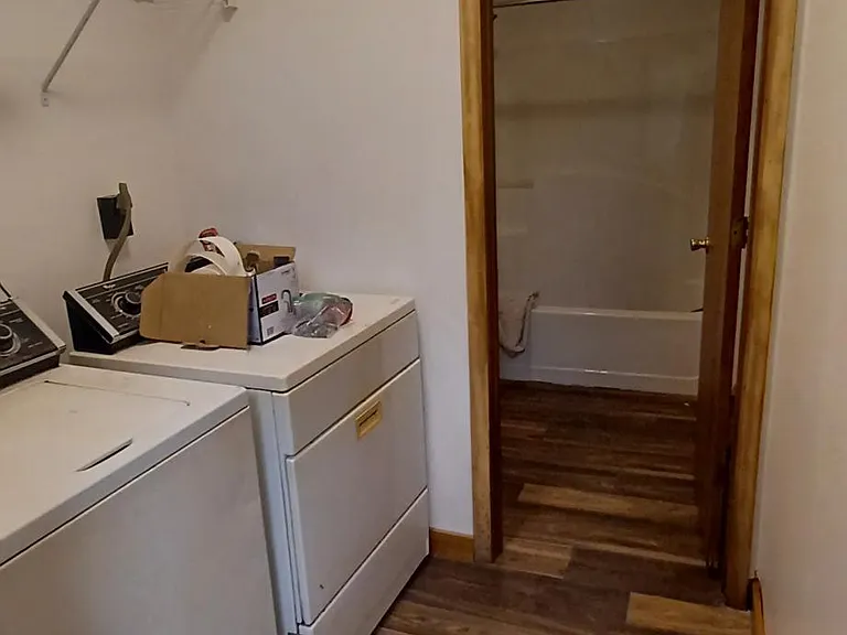 Laundry room & bathroom view from kitchen. Washer & dryer are provided and are NOT coin operated.