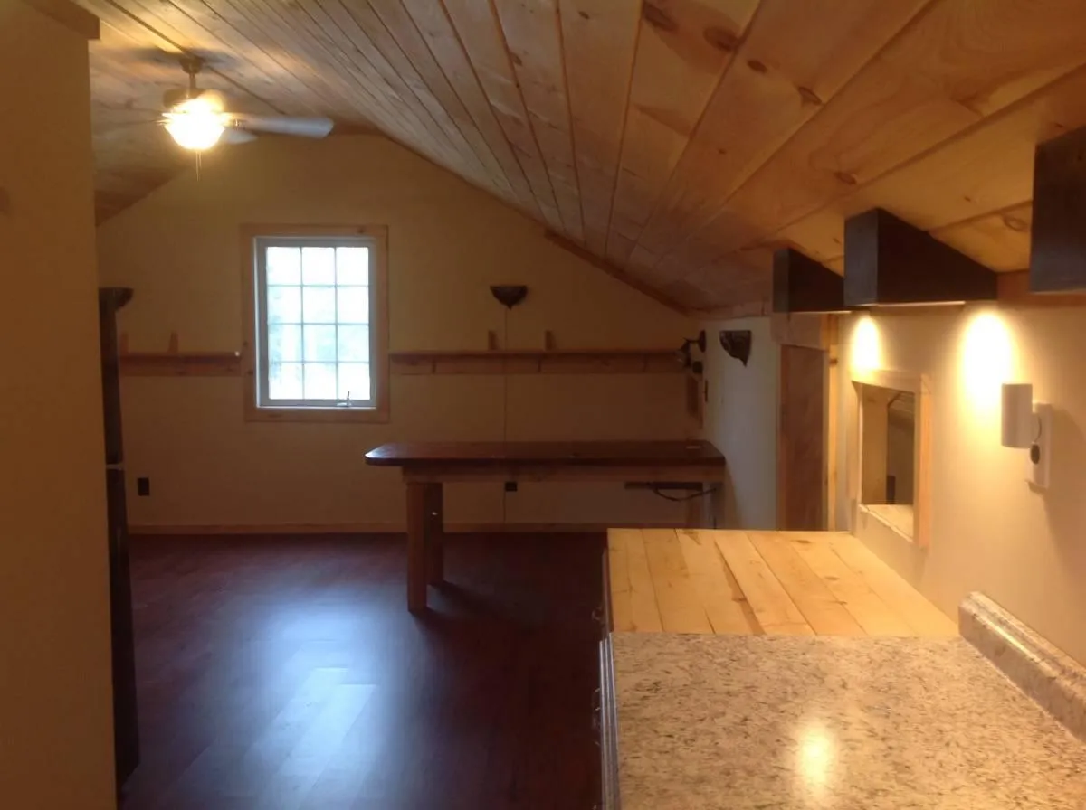 Kitchen facing out to the living area. Note the desk/table in the living area. It can be removed. - River Rd