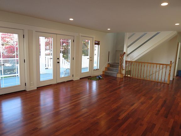 Main floor living room show stairs going up and stairs going down to Mother In Law unit
