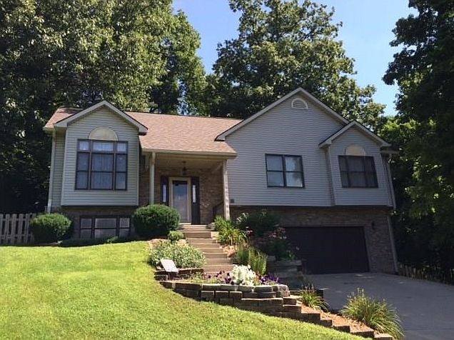Superb curb appeal. Nestled on cul de sac lot with wooded background