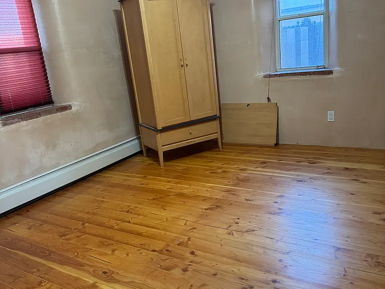 Second bedroom with two windows, hard wood floors, ceiling fan