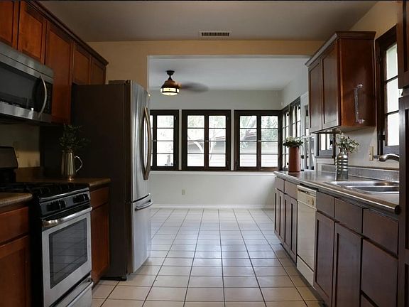 Nice shot of the family room through the kitchen and some of the many french windows-- the scale and proportions of the home combine to create a welcoming, calm space