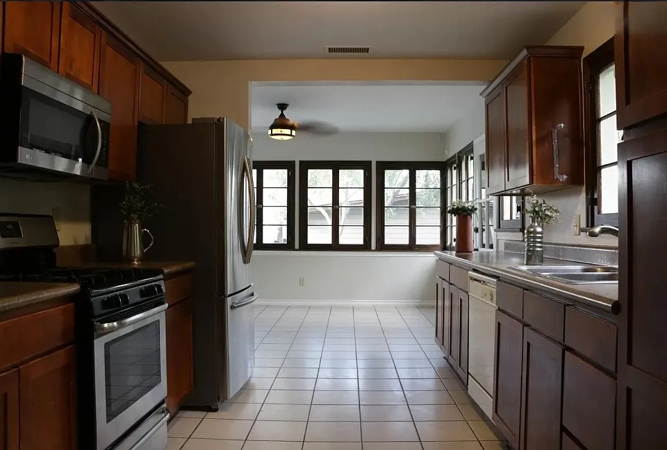 Nice shot of the family room through the kitchen and some of the many french windows-- the scale and proportions of the home combine to create a welcoming, calm space