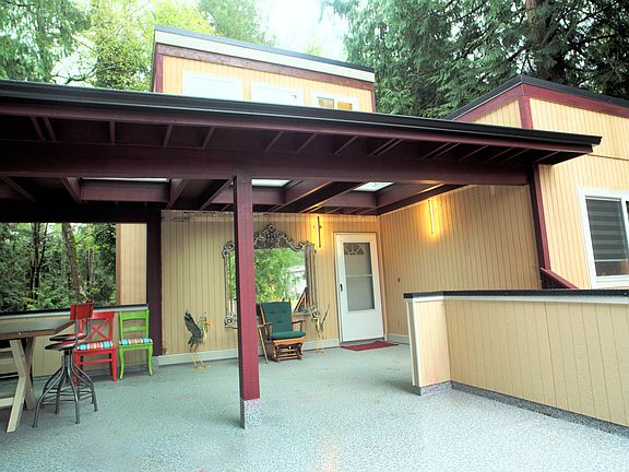 Expansive year-round front patio with covered awning and skylights.