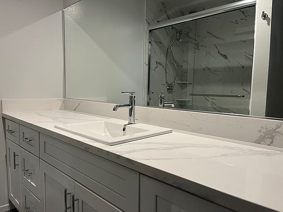Brand new master bath with quartz countertop.