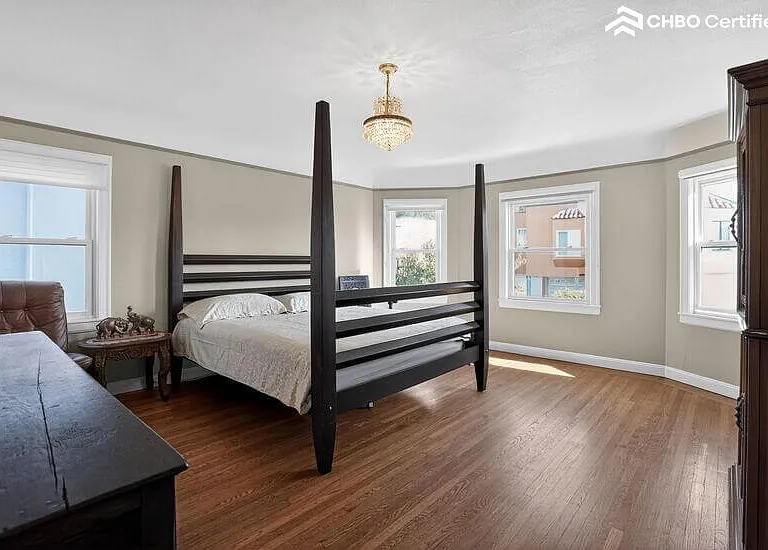 The main level bedroom has a 4-poster bed