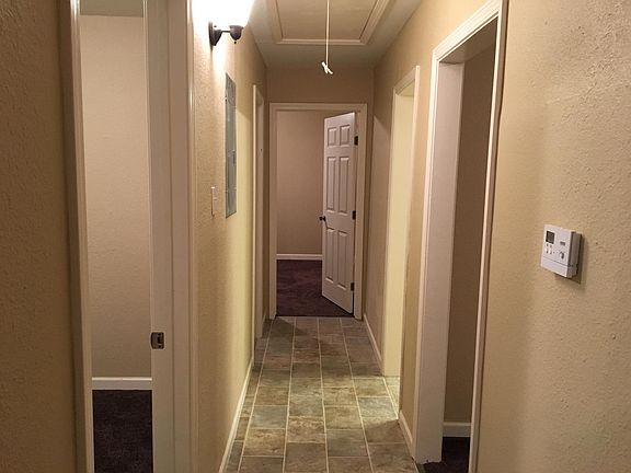 Hallway with 3 bedrooms and full bathroom