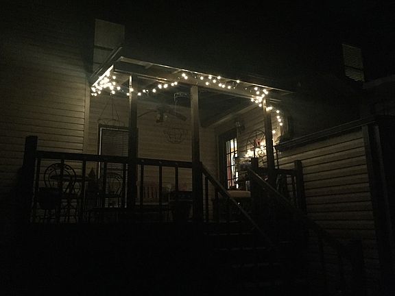 Back of house from yard at nighg