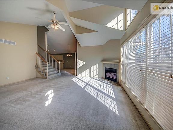 Bright, open great room with cathedral ceilings and fireplace.