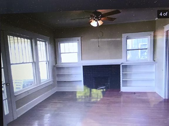 Amazing living room....with fireplace gas or natural woodburning) built in booksheves...and double french doors leads into dining room with original bay window and bench seat...