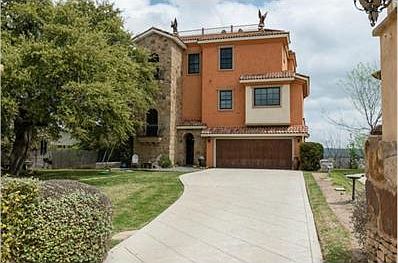 Beautiful stone and stucco design with manicured landscaping