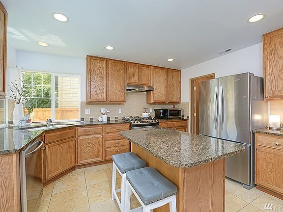 Kitchen features granite slab counter tops, stainless steel appliances, under mount lighting and an extra deep walk-in pantry. all appliances have been recently replaced and newer Hot water heater too!
