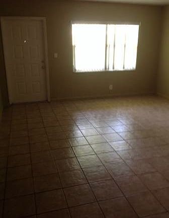 living room view from hallway looking at front door