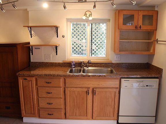 Kitchen sink and dishwasher and remodeled cabinets.