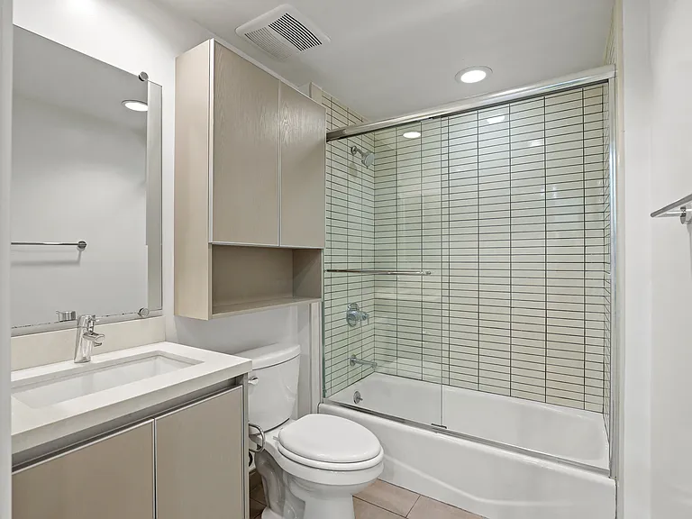 Bathroom with Full-Size Bathtub and Cabinet Storage