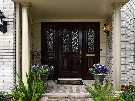 Your guests enter through a leaded glass front door and covered brick front patio