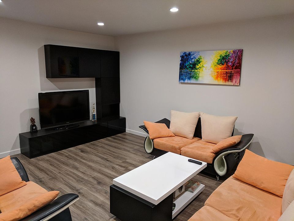 Spacious living room with modern furniture and a 55" TV