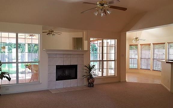 Open concept, gas fireplace, looks onto oversized patio.