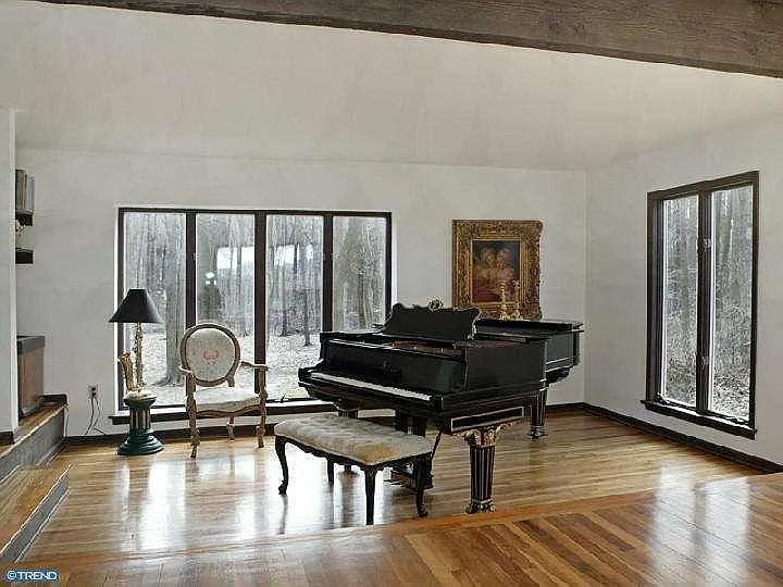 Sunken living room facing back of house containing Steinway Grand