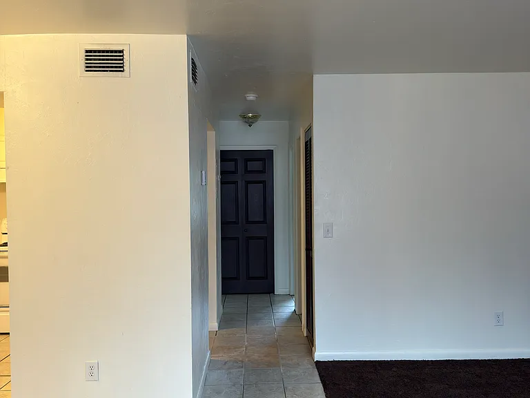 Hallway leading to bath and bedrooms.